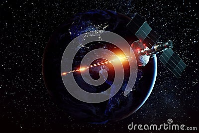 Space military satellite, a weapon in space shoots a laser against the background of the earth. Attack, technology, space war. Stock Photo