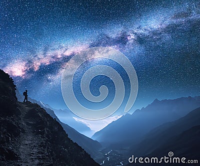 Space with Milky Way, girl and mountains at night Stock Photo