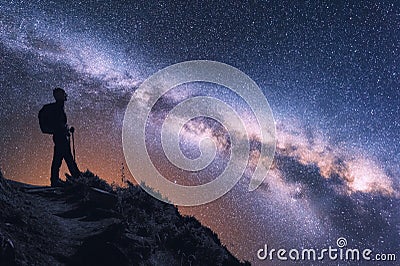 Space with Milky Way and silhouette of a woman with backpack Stock Photo