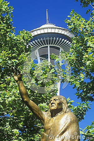 Space Needle with statue of Chief Seattle at base in Seattle, WA against blue sky Editorial Stock Photo