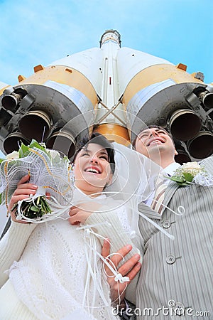 Space rocket over fiance and bride Stock Photo