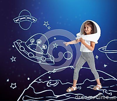 Contemporary artwork with little girl in huge white astronaut helmet standing among drawn planets, asteroids and stars Stock Photo