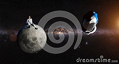 Astronaut sitting alone on a small moon Stock Photo