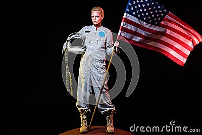 spacewoman in spacesuit holding helmet and american flag Stock Photo