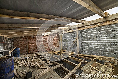 Spacious attic room under construction and renovation. Energy saving walls of large hollow foam insulation blocks and temporary Stock Photo