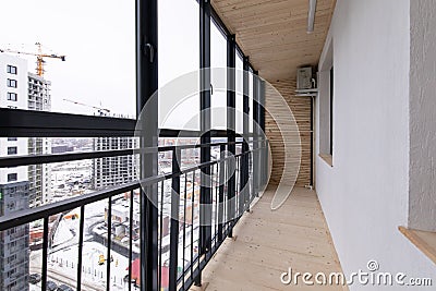 Spacious balcony, solid wood floors and floor-to-ceiling windows Editorial Stock Photo