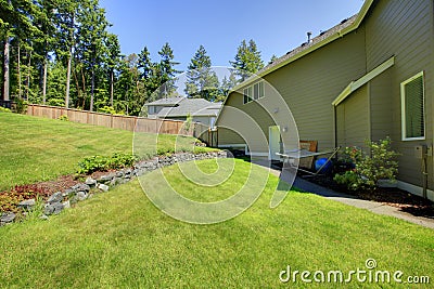 Spacious fenced backyard area with Natural Stone Landscaping. Stock Photo