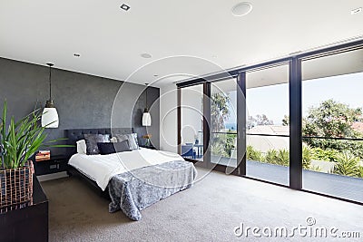 Spacious interior of designer master bedroom in luxury Australia Stock Photo