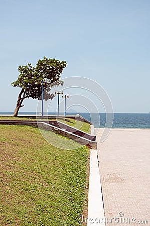 Spacious seafront inside city with lawn and lanterns Stock Photo
