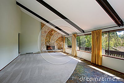 Spacious unfurnished living room interior with high vaulted ceiling and stone trim fireplace Stock Photo
