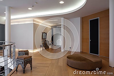 Spacious upstairs hallway in luxury house with stylish carved furniture Stock Photo