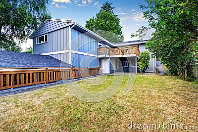 Spacious wooden fenced backyard area. Countryside blue house. Stock Photo