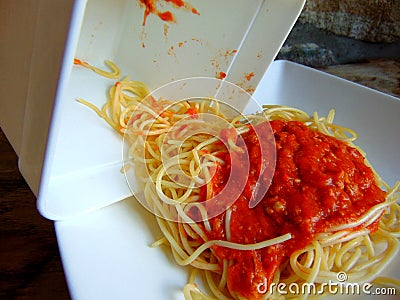 Spaghetti leftovers from a plastic container Stock Photo