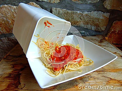 Spaghetti leftovers from a plastic container Stock Photo