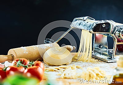 Spaghetti machine cutting dough into noodles Stock Photo