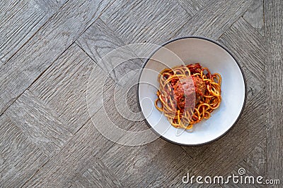 Spaghetti and meatballs in a bowl on a table Stock Photo