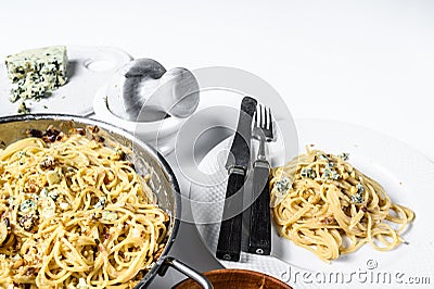 Spaghetti pasta with blue Gorgonzola cheese sauce. White background. Top view. Copy space Stock Photo