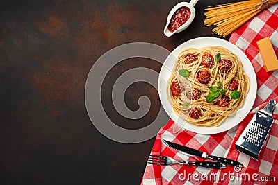 Spaghetti pasta with meatballs, cherry tomato sauce on rusty background Stock Photo