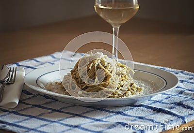 Spaghetti with Pesto Genovese and Pecorino Romano cheese glass of Vernaccia tuscany white wine Stock Photo