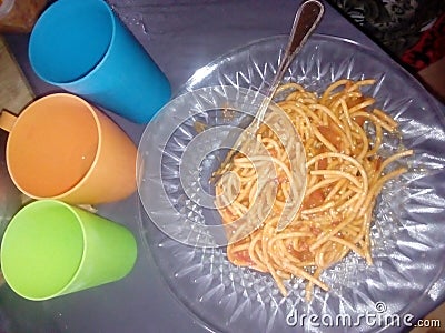 Spaghetti plate fork three plastic glasses Stock Photo