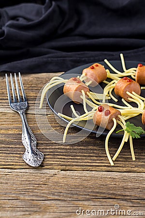 spaghetti with sausages in the form of spiders. Happy kid food for Halloween party Stock Photo
