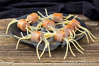 spaghetti with sausages in the form of spiders. Happy kid food for Halloween party Stock Photo