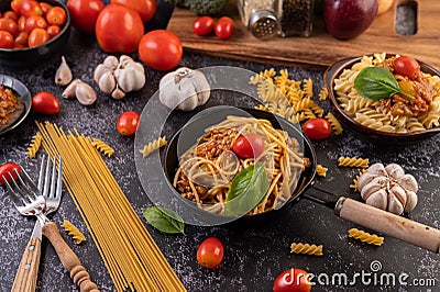 Spaghetti sauteed in a pan-fried with tomatoes and basil Stock Photo