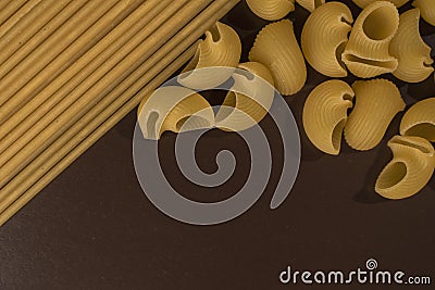 spaghetti and shells on a brown background Stock Photo