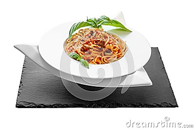 Spaghetti tuna pasta basil plate triangle shape slate table pretty Stock Photo