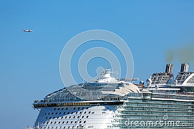 Cruiser ship and a landing aircraft at Barcelona Editorial Stock Photo