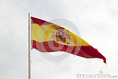 Spain flag on a blue sky with clouds background Stock Photo