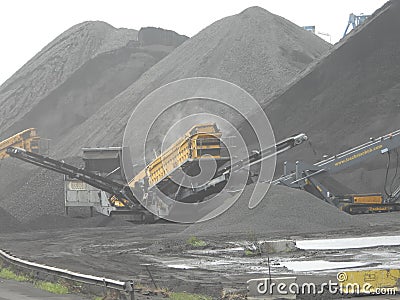 Spain: mountains of charcoal at Tarragona's harbour Editorial Stock Photo