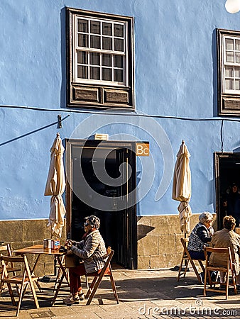 Street view with beautiful ancient houses and people sitting on the cafe Editorial Stock Photo