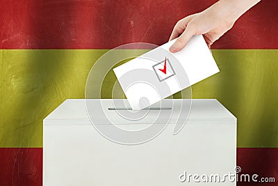 Spain Vote concept. Voter hand holding ballot paper for election vote on polling station Stock Photo