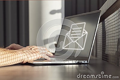 Spam email. Man receiving junk mail, unwanted messages, ads for money scams while working on laptop. Hands on keyboard Stock Photo