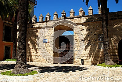 Wall with battlements and large gate in the castle courtyard, Jerez de la Frontera, Spain. Stock Photo