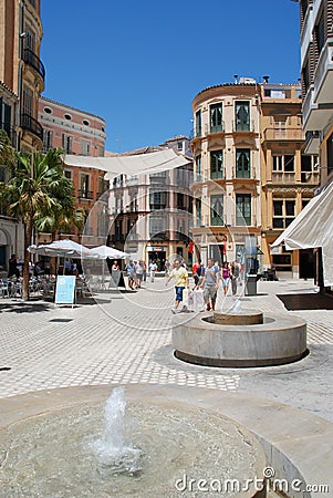 Fountains and pavement cafes in the city plaza, Malaga, Spain. Editorial Stock Photo