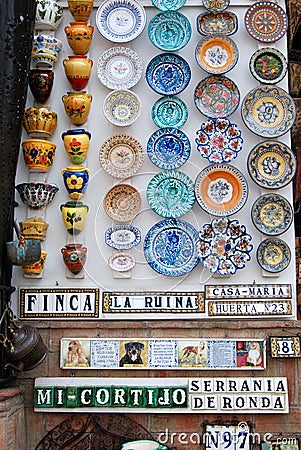 Colourful ceramic plates and pots on a shop wall, Ronda, Spain. Editorial Stock Photo