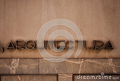 Spanish Arquitectura word meaning Architecture on a stone facade wall Stock Photo