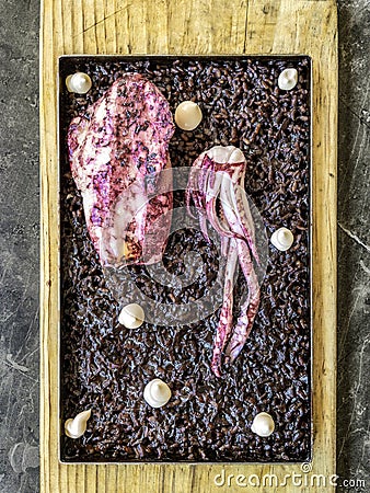 Spanish Black Rice (Arroz Negro a la Llauna) with squid, cooked on a Llauna Stock Photo