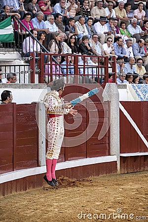 Spanish bullfighter Juan Jose Padilla jumping and suspended in the air with two banderillas in the right hand looking at the bull Editorial Stock Photo