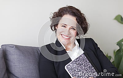 Spanish Businesswoman Smiling At the Camera. At the office. Stock Photo