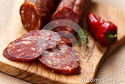 Spanish chorizo sausage with parsley on rustic boa Stock Photo