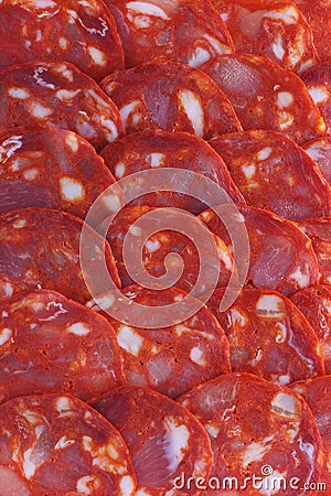 Spanish chorizo sausage pieces background Stock Photo