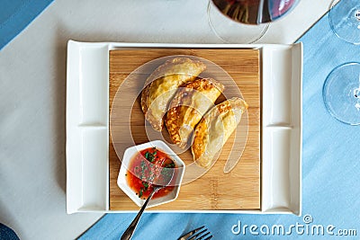 Spanish empanadas with sauce on restaurant table Stock Photo