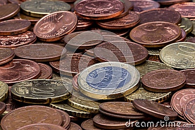 Spanish euro coin amidst a lot of dirty used eurocent coins Stock Photo