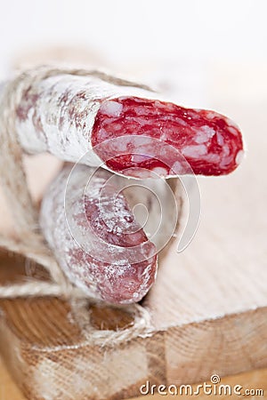 Spanish fuet salami cuts tied by string Stock Photo