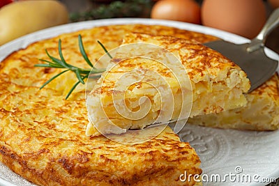 Spanish omelette with potatoes and onion, typical Spanish cuisine. Tortilla espanola. Rustic dark background Stock Photo