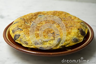 Spanish potato omelette with Japanese shitake mushrooms and onion. Traditional tapas recipe. Stock Photo