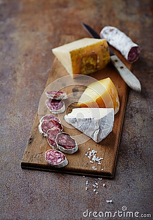 Spanish Salami, Brie and Hard Cheese on a Wooden Board Stock Photo